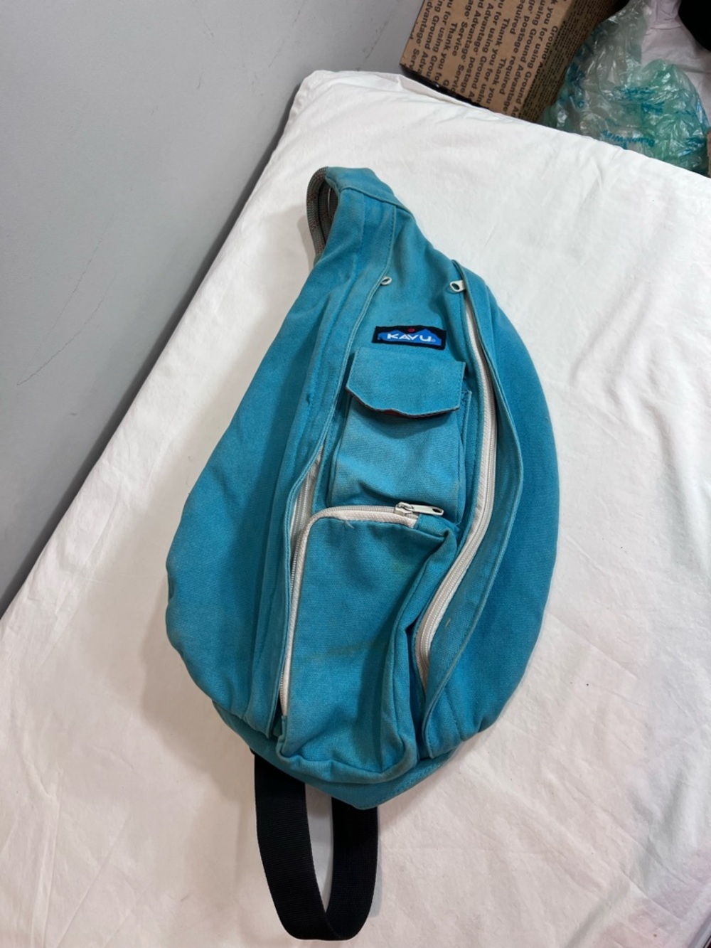 Kavu teal rope sling bag backpack